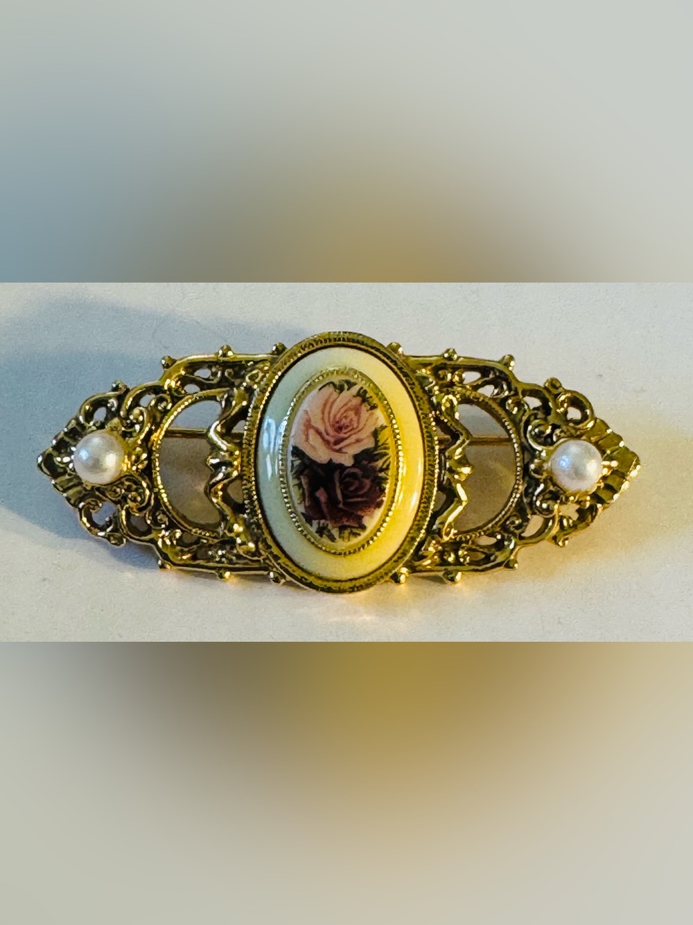 1928 gold tone and faux pearl brooch